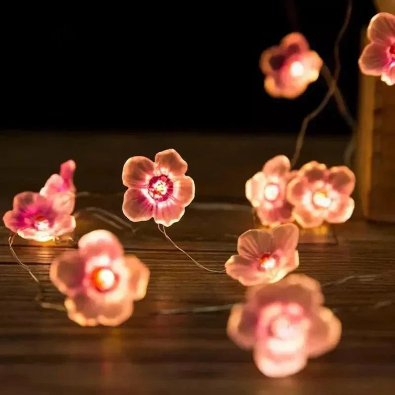 Guirlande lumineuse féerique en fleurs de cerisier roses