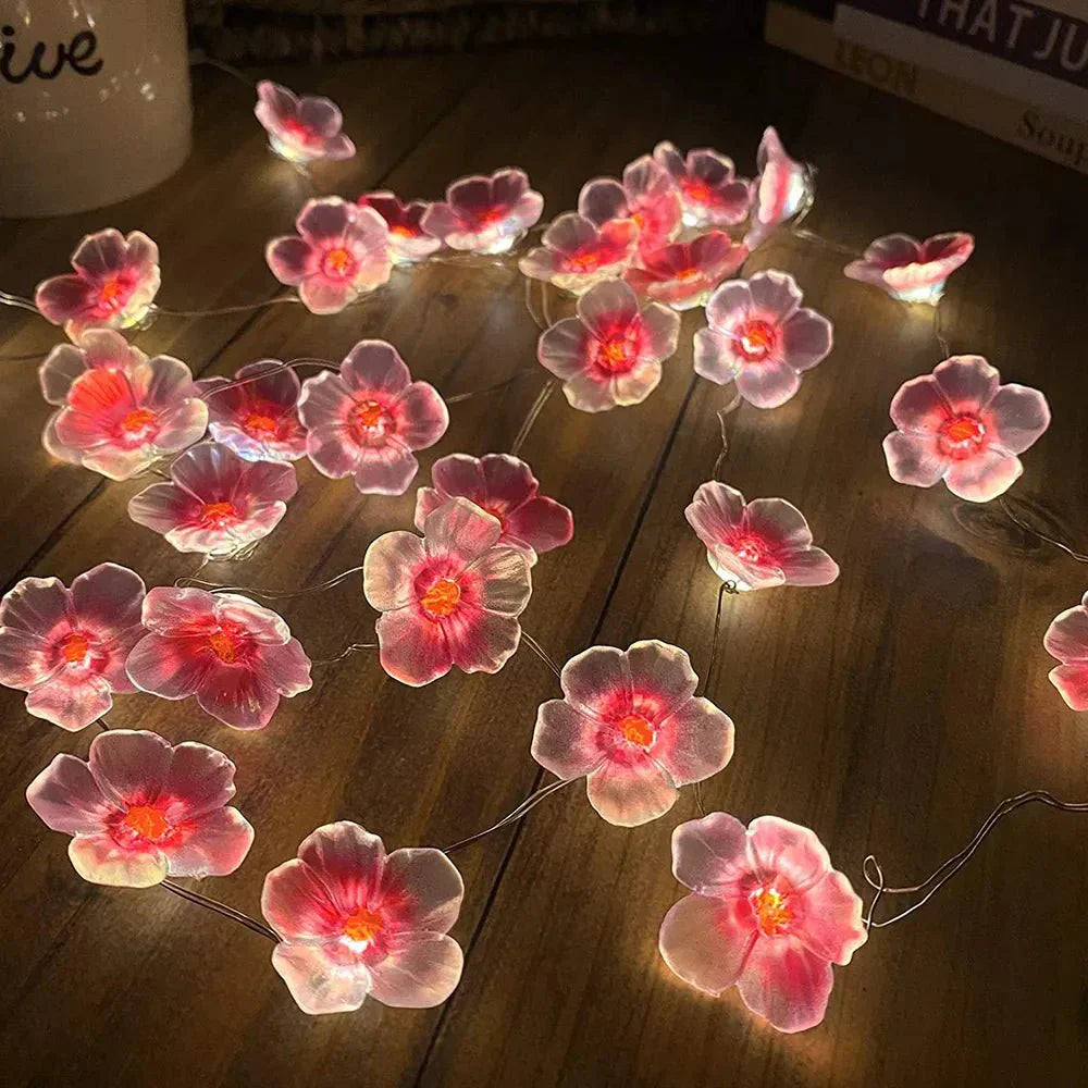 Guirlande lumineuse féerique en fleurs de cerisier roses